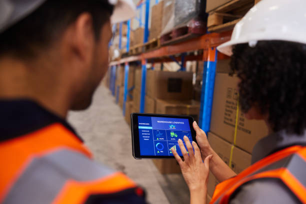 istock Engineers using an app to trace shipments in a large warehouse 1852112668