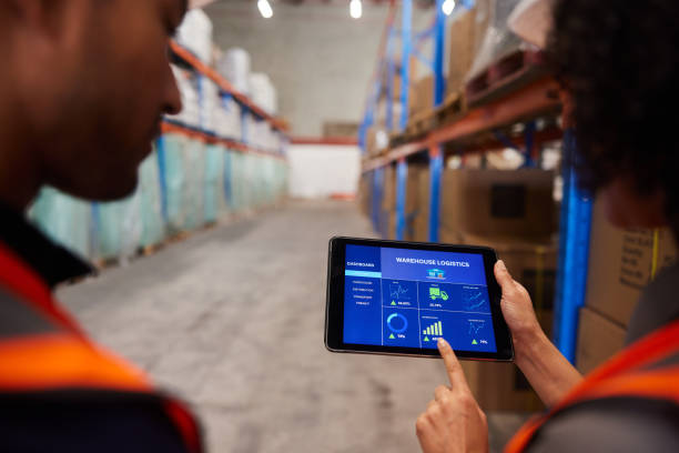 istock Engineers using an app to track shipments in a large warehouse 1852113645