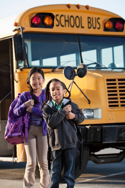 istock Children standing outside school bus 185211456