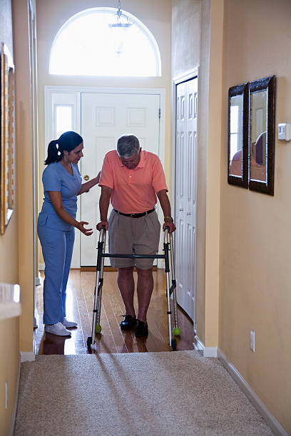 istock Home health aide with senior man 185211548