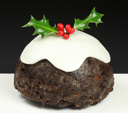 Christmas pudding with icing and holly
