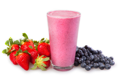 Fruit smoothie shown with fresh fruit