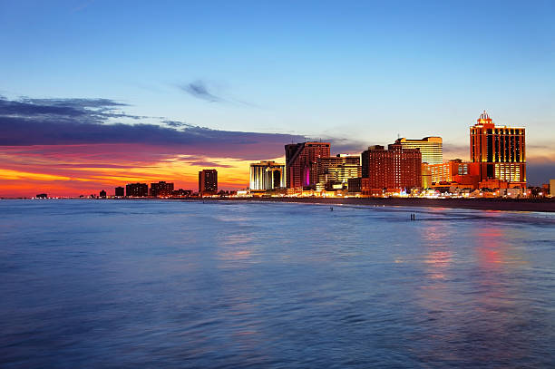 Atlantic City Atlantic City skyline hotel casinos along the oceanfront. Atlantic City located on the Jersey shore is a resort city on Absecon Island  in Atlantic County, New Jersey. Atlantic City is known for its two mile long boardwalk, gambling casinos, great nightlife, beautiful beaches, and the Miss America Pageant. new jersey stock pictures, royalty-free photos & images