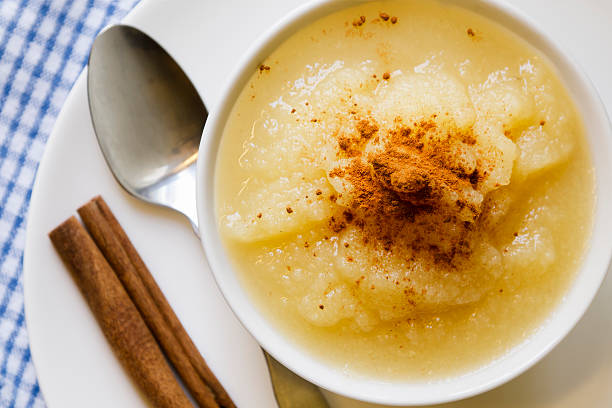 Applesauce with Cinnamon in a White Bowl Viewed from Above stock photo