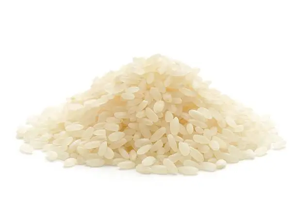 "Calrose rice used in making Shush, in a heap isolated on a white background."