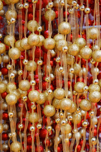 A background with golden Christmas balls an ribbons.