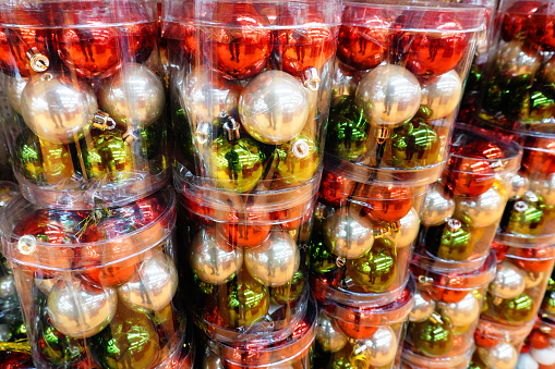 A Christmas background with colorful Christmas balls in transparent plastic boxes.