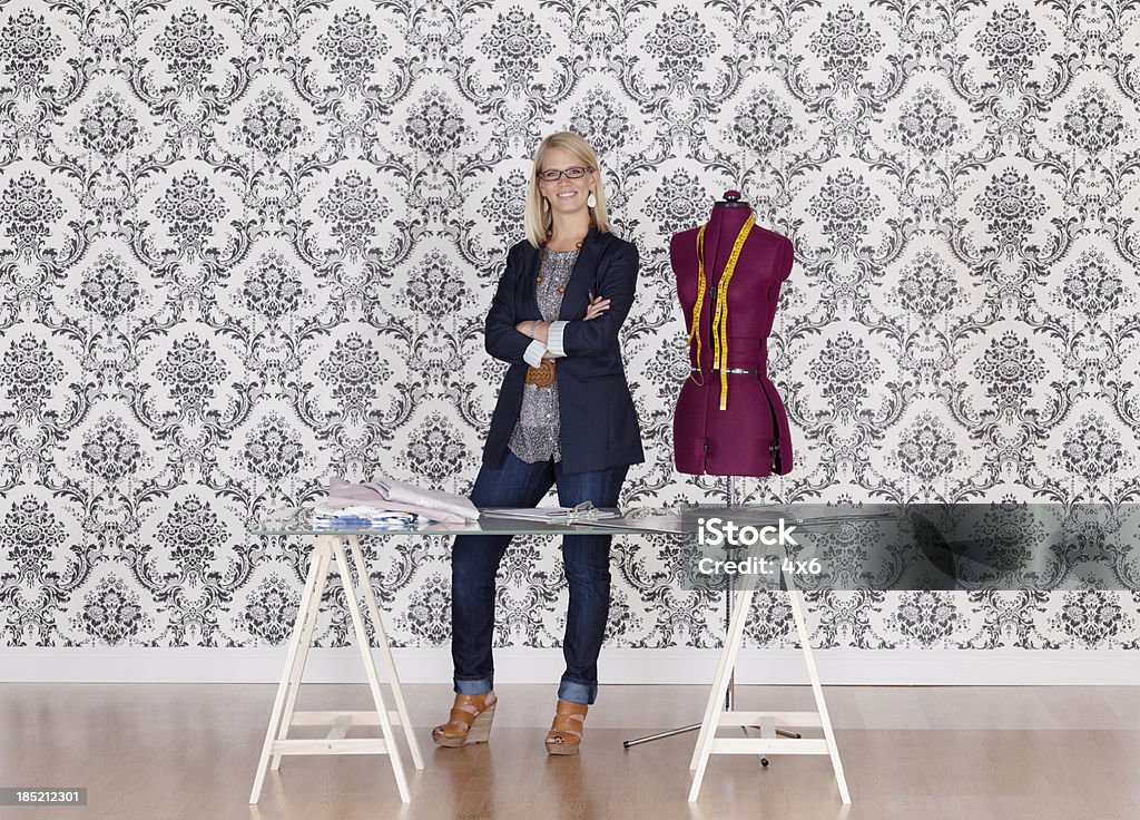 Fashion designer standing in her workshop Tailor Stock Photo