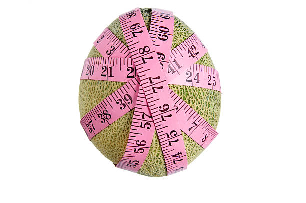 measuring tape on melon stock photo