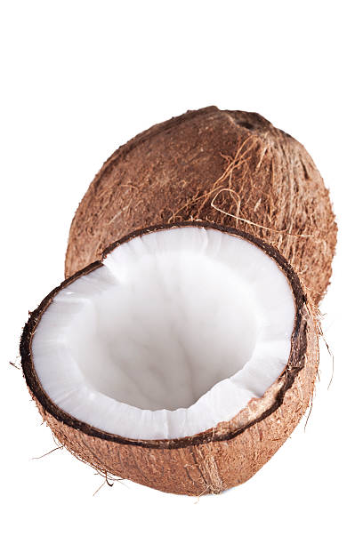 A fresh coconut cut in half on a white background stock photo