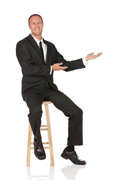 istock Businessman sitting on a stool and gesturing 185212872