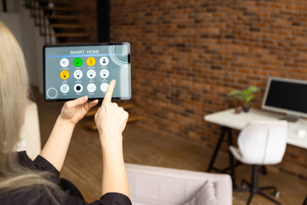 istock young woman using smart home app to control light turning on with tablet pc 1852131199