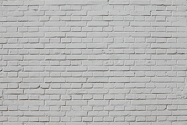 white brick wall - concret stock-fotos und bilder