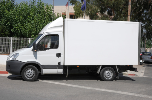 Small delivery truck with a refrigerated unit.