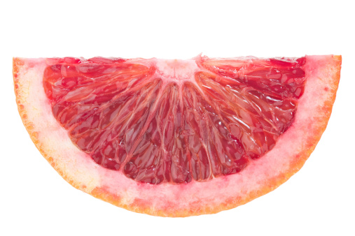 An extreme close up shot of a blood orange slice. Isolated on white.