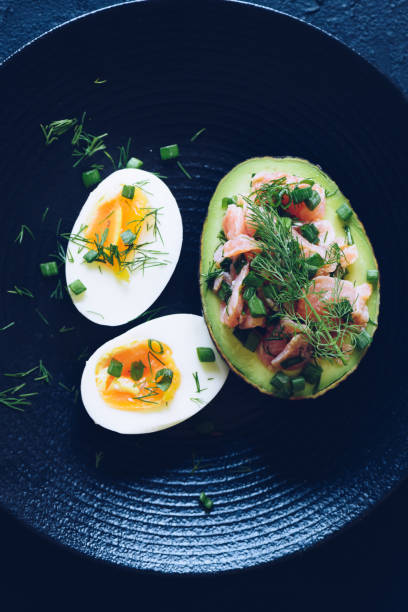 istock Healthy breakfast with eggs and stuffed avocado with salmon 1852149008