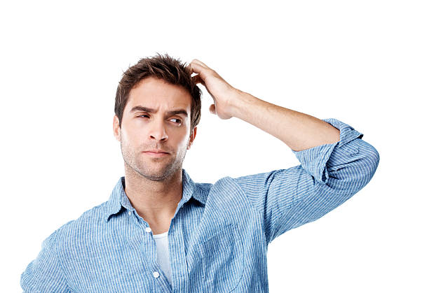 Hmm,this is trickier than I thought Handsome man thinking while scratching his head and isolated on white confused face stock pictures, royalty-free photos & images