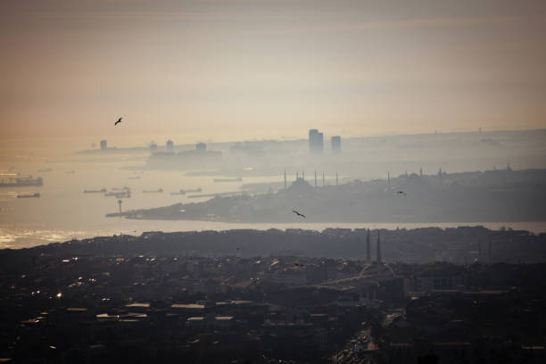 Aerial view of Celiktepe district of Istanbul during sunset hours. A mosque is surrounded by numerous buildings where no park or grove is visible. Total mayhem of cement and concrete.