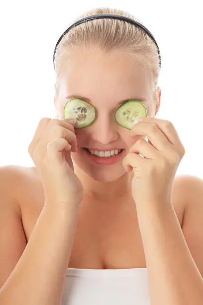 young beauty is covering her eyes with cucumberslices**MORE PICS ARE HERE: