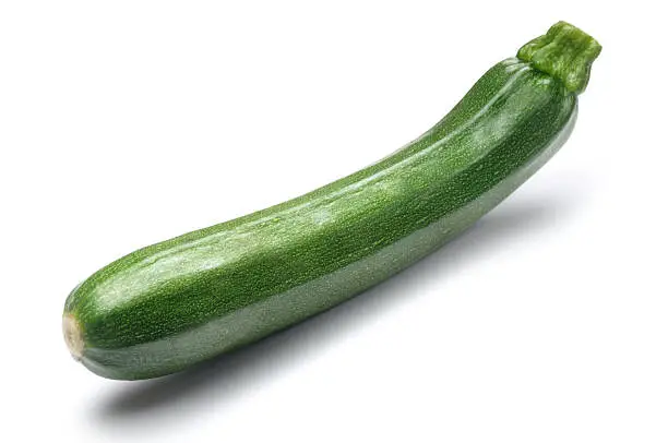 Single courgette isolated on white.