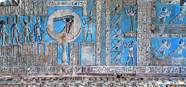 "The vibrant astronomical ceiling of the Hypostyle Hall, Temple of Hathor Dendera, Egypt.  The ceiling is a symbolic representation of the heavens, featuring the waxing and waning of the moon as it travels across the heavens in the barque of Re.  Jackals and birds accompany Reaas barque.  This scene is from the west side of the temple and features the head of the falcon god Horus in a solar disk and various gods, including the ibis-headed god Thoth.  Dedicated to Hathor, goddess of love, beauty, music and motherhood, the main temple dates from the Graeco-Roman era although a temple stood on the site during the Old Kingdom."