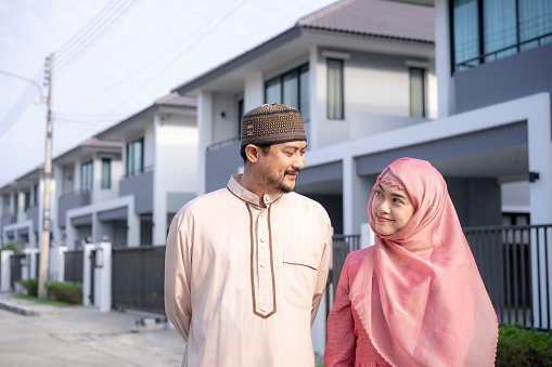 Young Muslim man and woman delighted with their new home