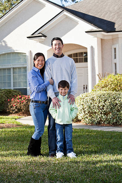 istock Family in front of house 185215612