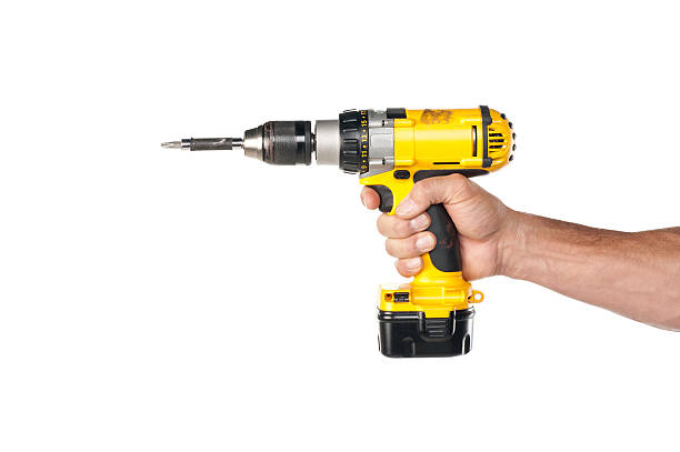 Male Hand Holding A Powere Drill "Male handyman's hand holding an electric power drill, shot against a white background.Take a look at our lightbox's of other related images." drill stock pictures, royalty-free photos & images