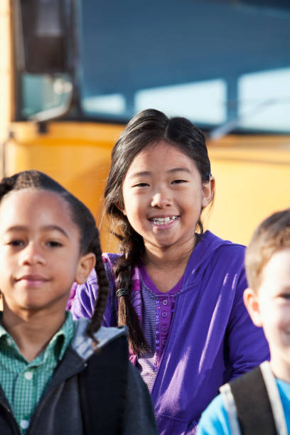istock Children standing outside school bus 185215650