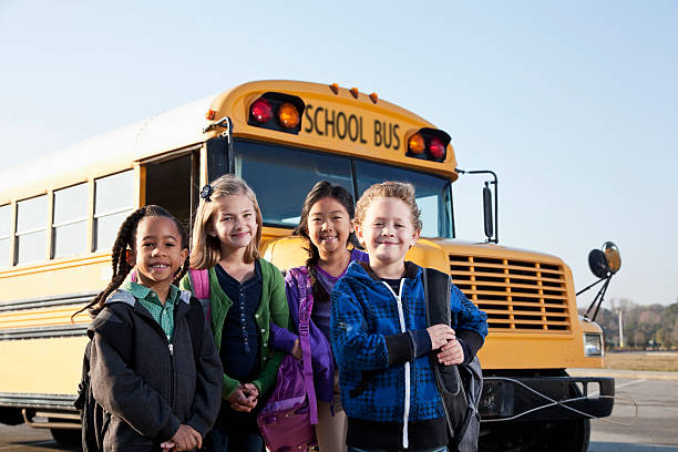 istock Children standing outside school bus 185215651