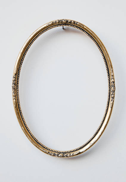 istock Ornate oval carved gilded picture frame on white wall. 185215930
