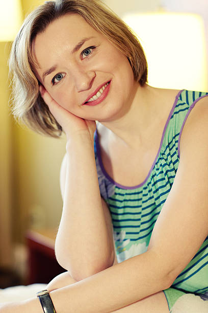 istock Lovely woman sitting in bed smiling 185216056