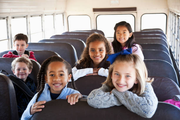 bambini seduti all'interno di scuola bus - sc0536 foto e immagini stock