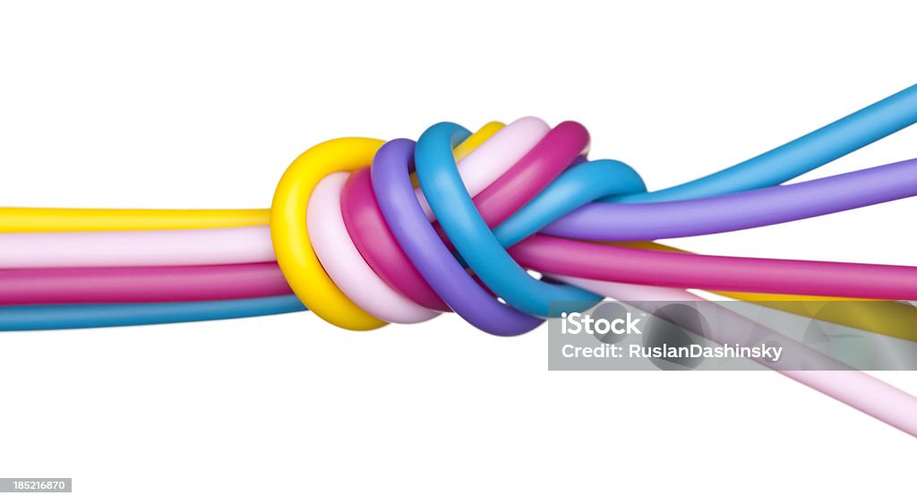 Teambulding concept. Team work / team building concept - close up bundle of colored wires go and split, isolated on white. Team Building Stock Photo