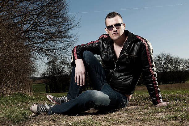 istock Man with leather jacket sitting in landscape 185217157