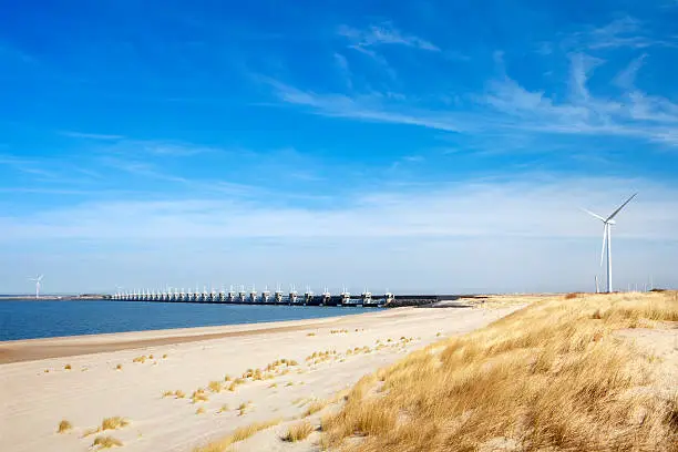 "The Eastern Scheldt storm surge barrier (Oosterscheldekering) in the Dutch province of Zeeland. This is the largest of dams of the Delta Works. The Delta Works protect a large area of land around the Rhine, Meuse and Scheldt delta against flooding. After the disastrous North Sea flood of 1953, measures were taken to start the construction of the Delta Works."