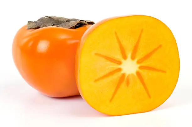 One and half Persimmons on white background.