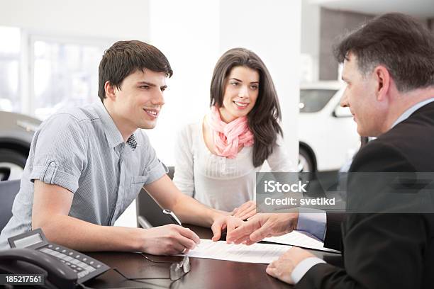 Couple Buying Car Stock Photo - Download Image Now - Car Rental, Desk, 25-29 Years
