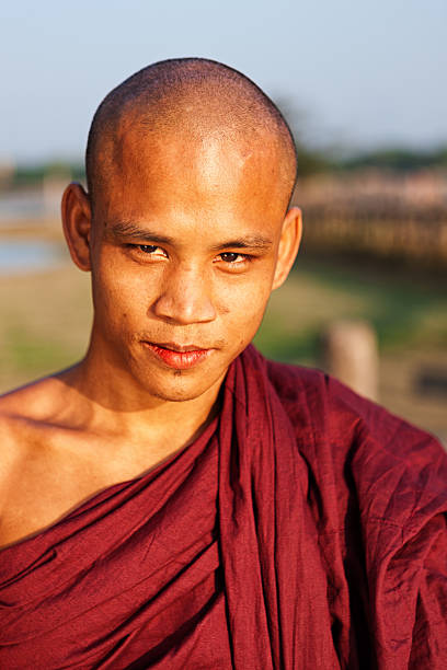 istock Buddhist Monk crossing U Bein Bridge 185217644