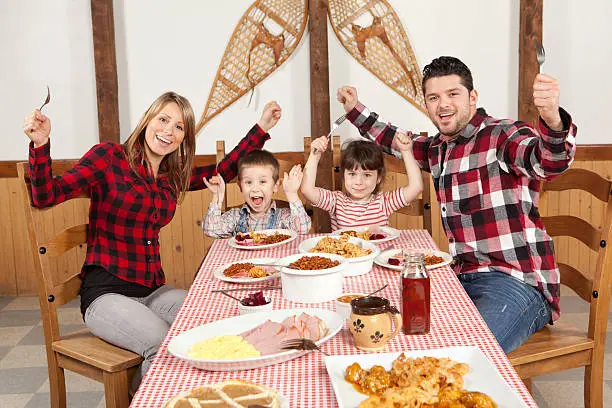 Photo of happy family having meal at sugar shack