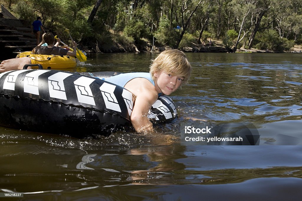 Tubing On The River "A young boy on an inflatable tube one the river, Dwellingup Western Australia." Inflatable Swim Ring Stock Photo