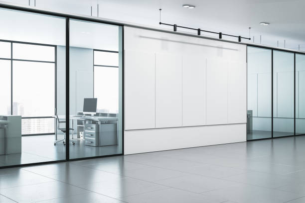 istock Modern office corridor with concrete walls and floor, windows with city view and reflections. 3D Rendering. 1852183627