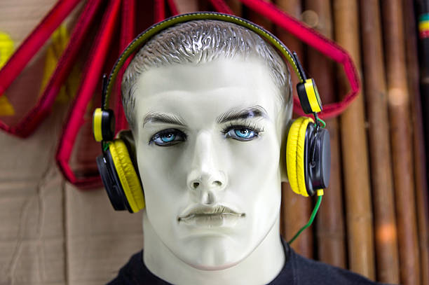 Male mannequin with earphones looking at the camera