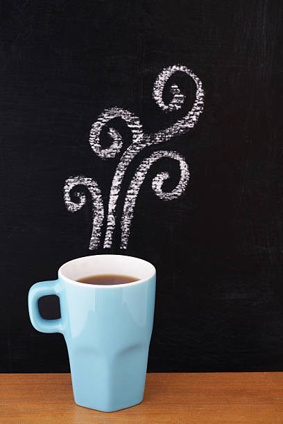 istock Hot coffee with fume drawn with chalk in black background 185218799