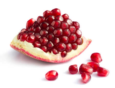 Piece of pomegranate on white backgroundMore fruits and berries: