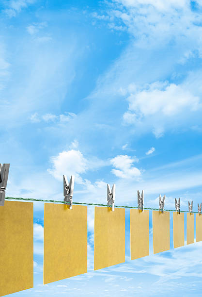 Blank yellow post it notes drying on a clothes line Blank Paper Post it notes being recycled and dried on a washing line blank yellow post it notes drying on a clothes line stock pictures, royalty-free photos & images