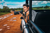 Young man on safari journey by off-road car in Sri Lanka.