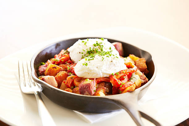istock Poached eggs on top of potatoes in iron skillet 185219231