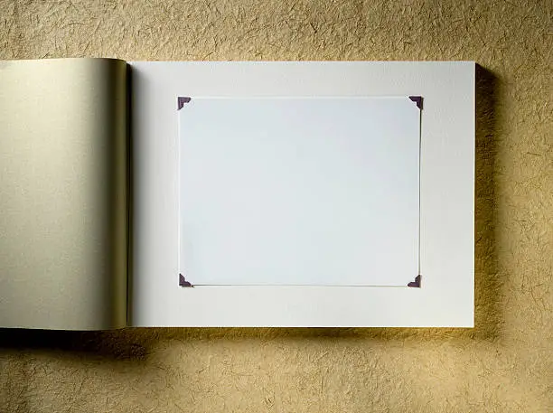 Blank traditional photo album on a paper background.