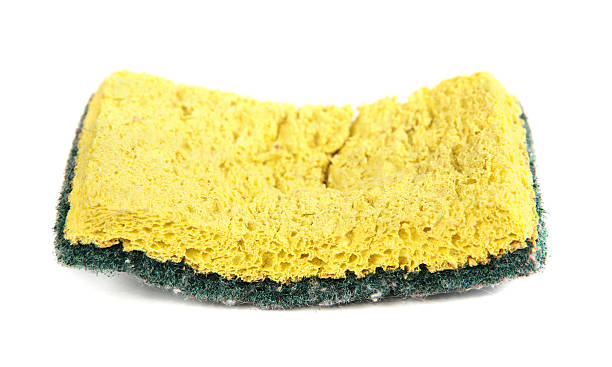 Used sponge isolated on white "Used yellow and green sponge, isolated on white background." cleaning sponge stock pictures, royalty-free photos & images